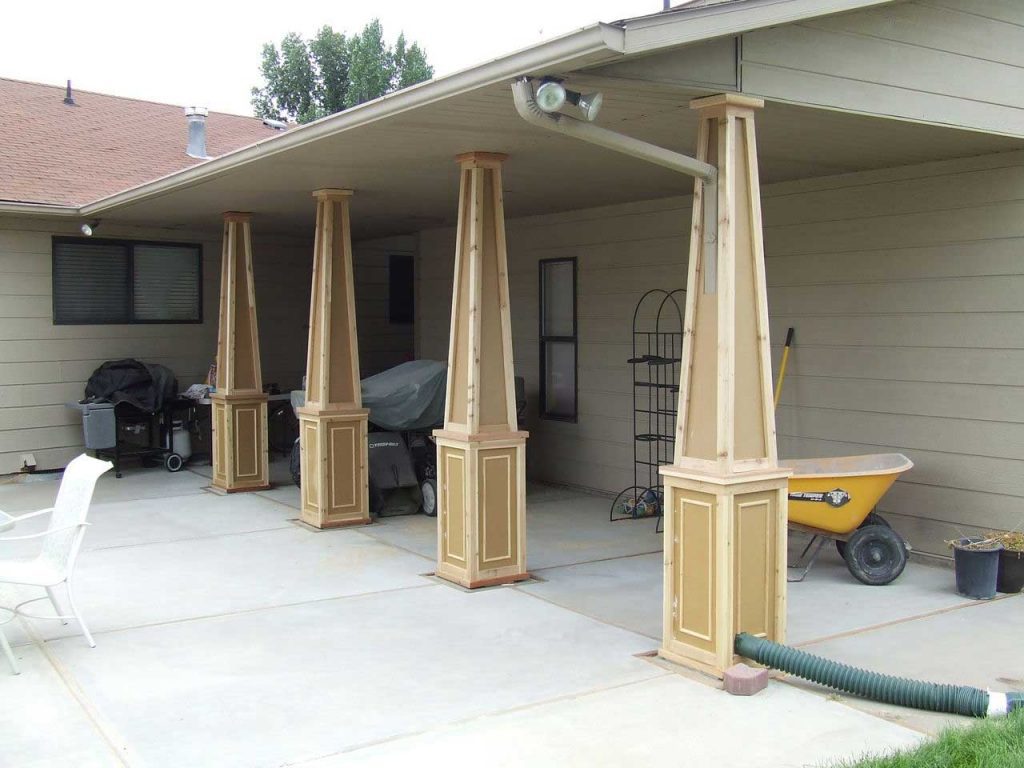 Backside area of a residential property with porch columns in stained wood and a craftsman-style base unit